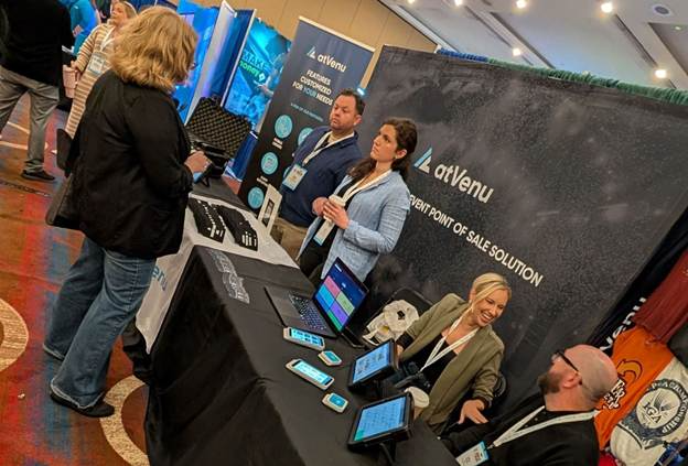 Trade show booth with table across the front separating staff from attendees and limiting engagement