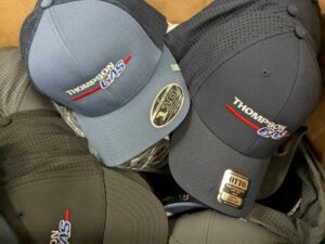 Close-up embroidered company logo showing thread texture and dimensional color effect on apparel