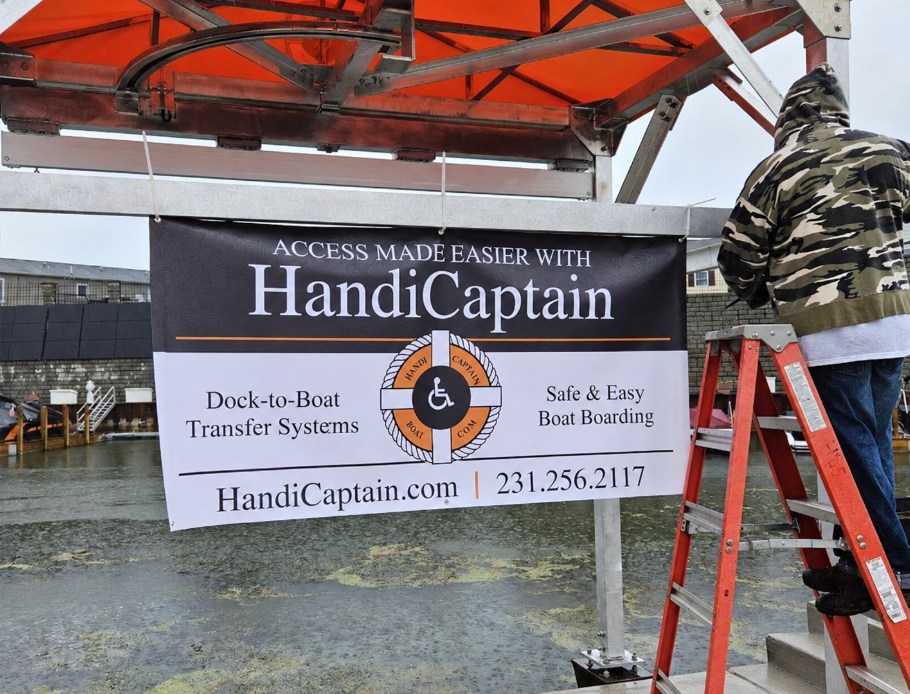 HandiCaptain branded banner installed at a waterfront boat boarding station